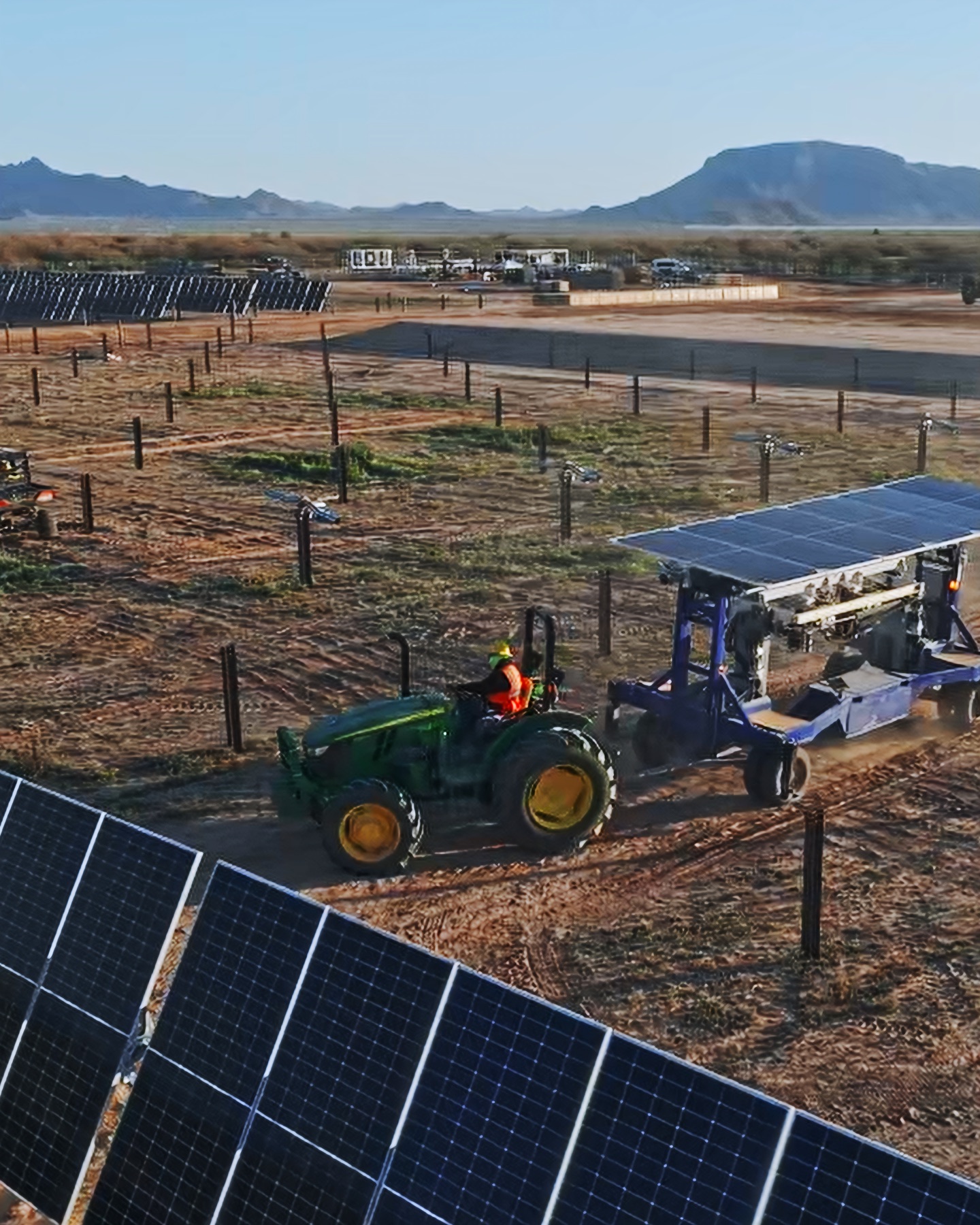 A Charge team member works beneath a solar bay.